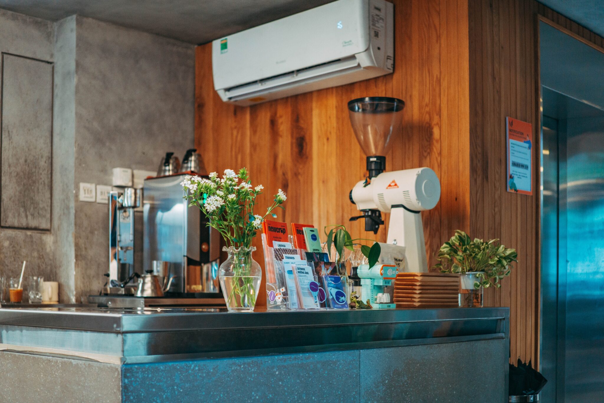 Wall-mounted ductless AC unit above a coffee bar in a wood-paneled room